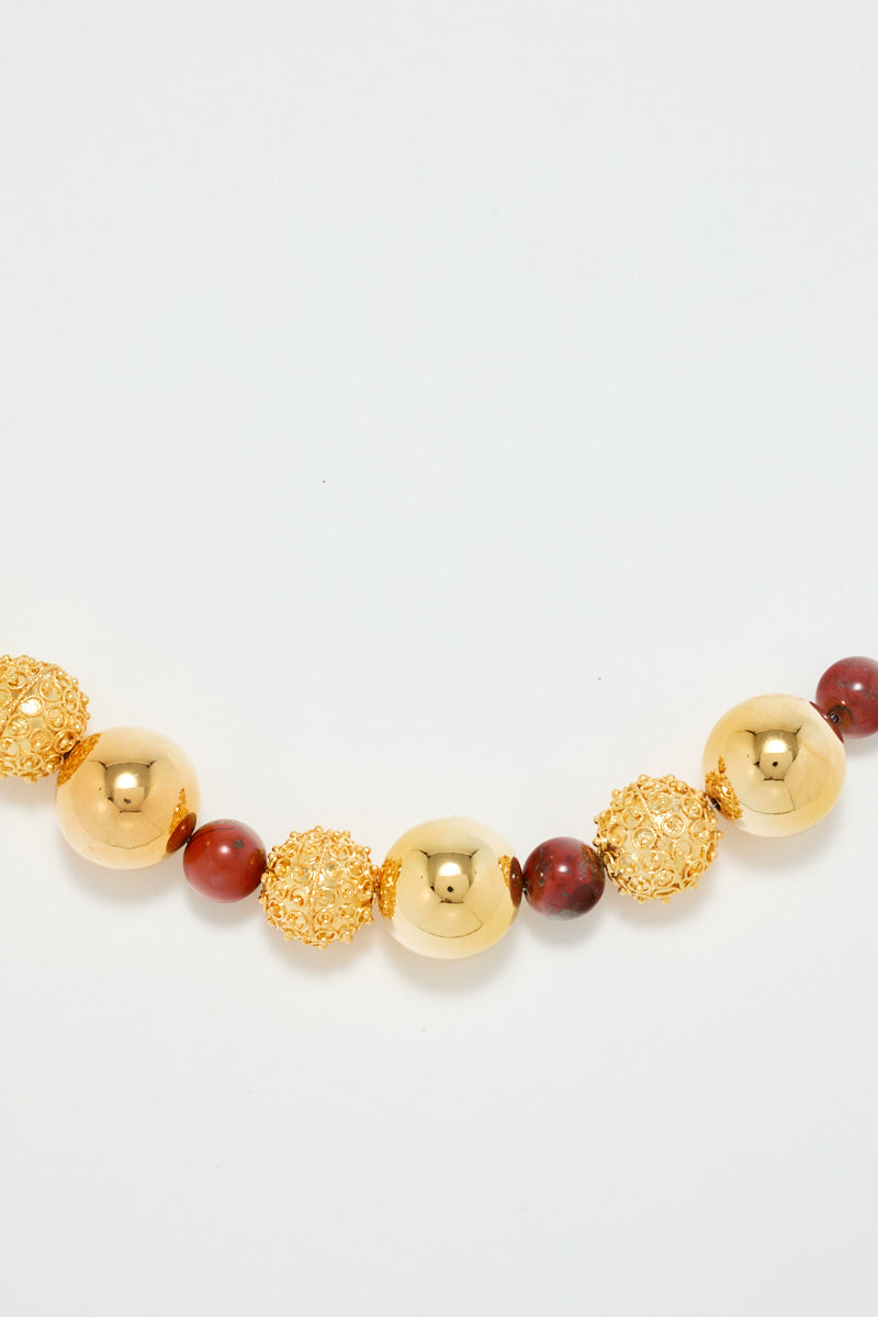 Gold Bracelet With Red Pearl Detail