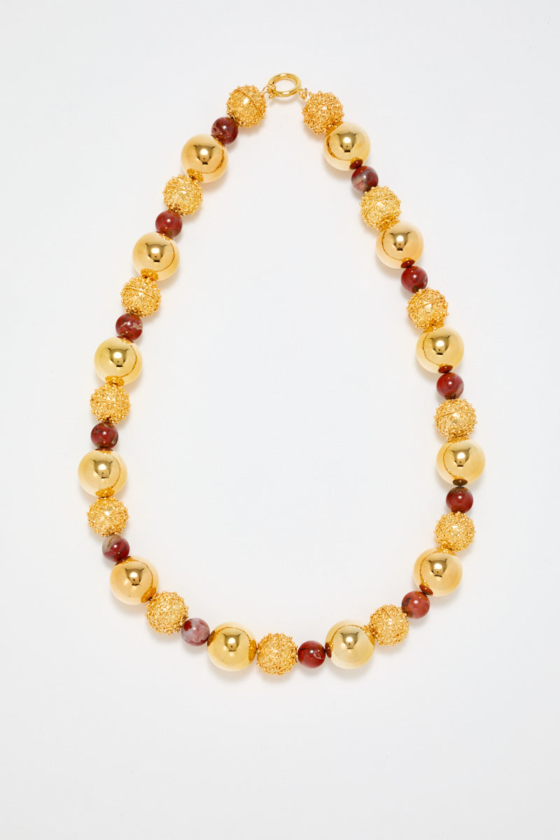 Gold Sculptural Necklace With Red Pearl Detail
