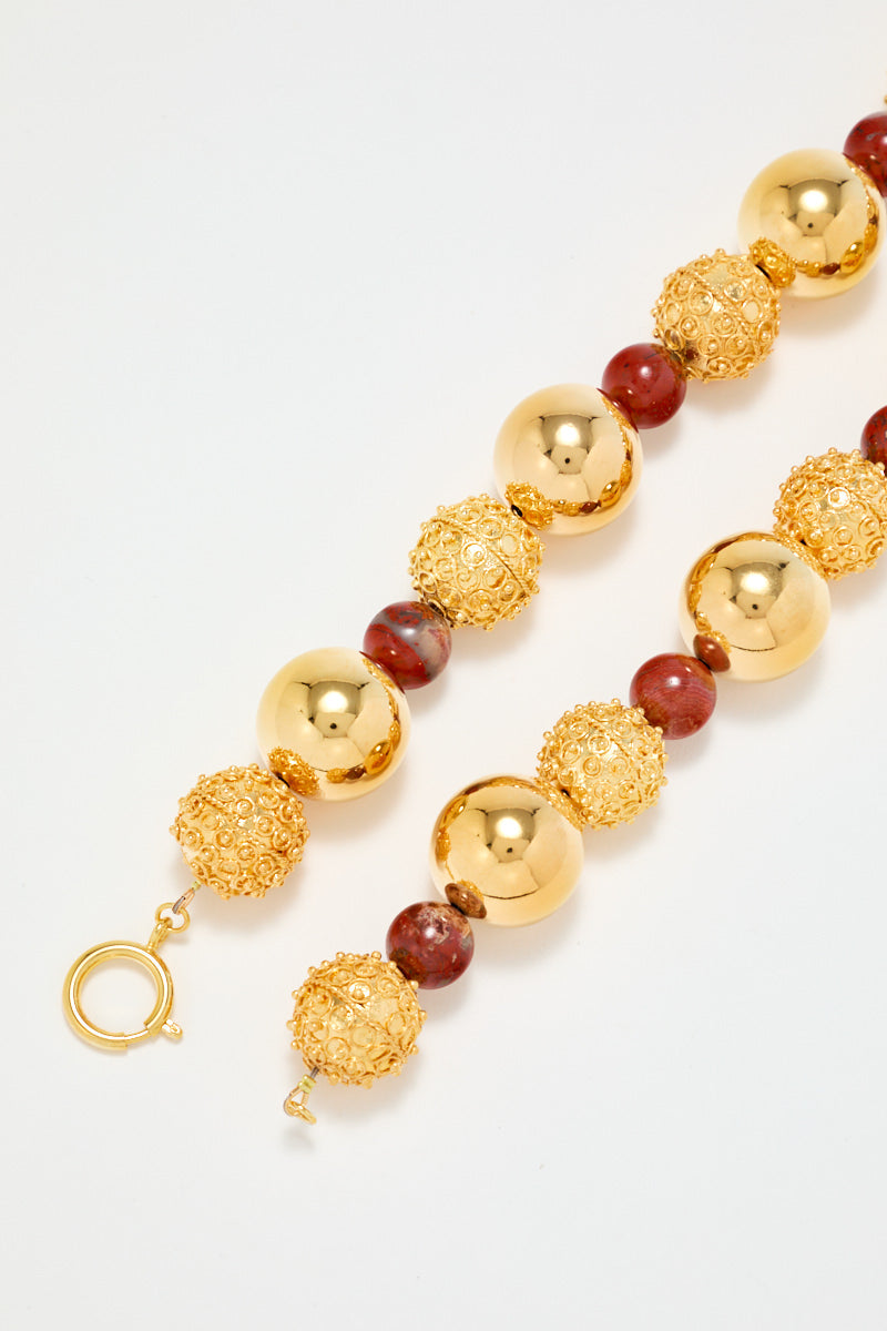 Gold Sculptural Necklace With Red Pearl Detail
