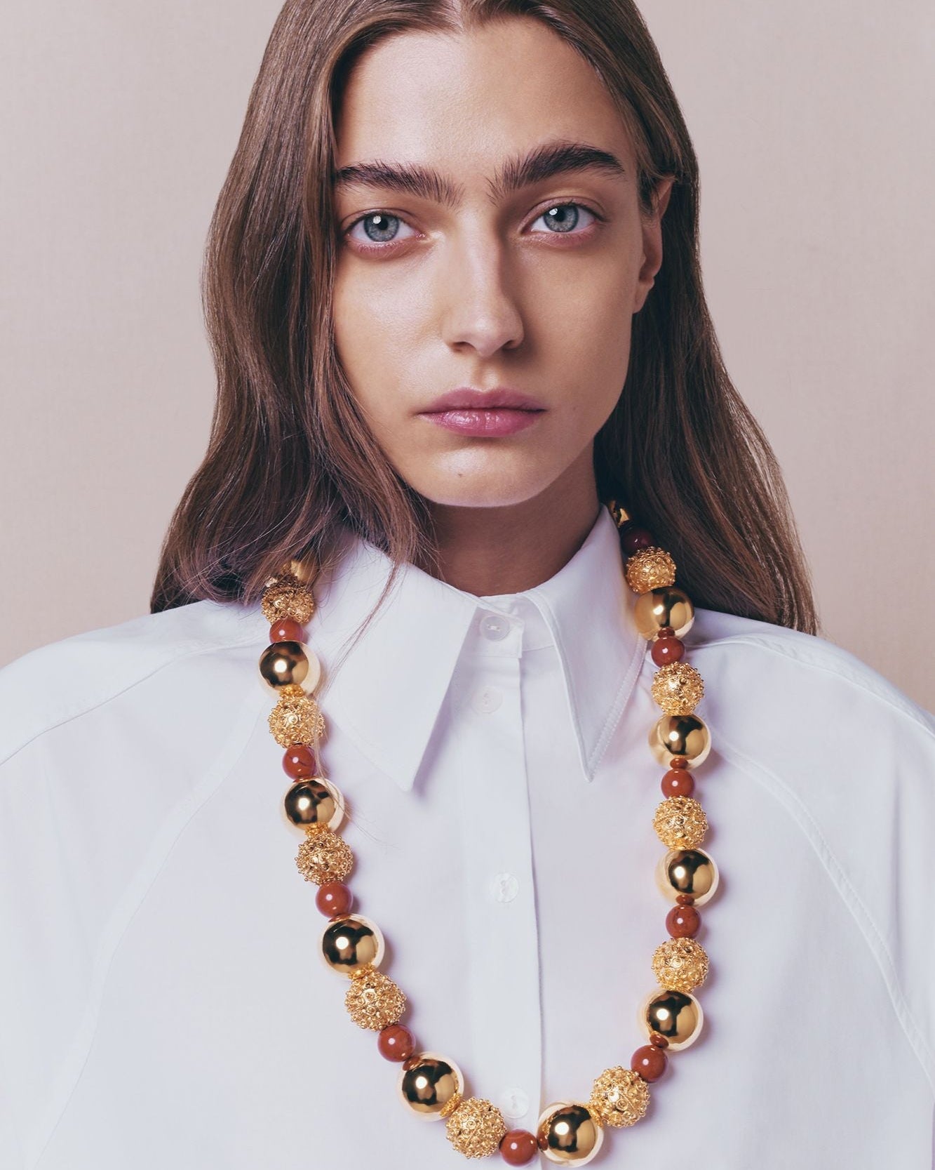 Gold Sculptural Necklace With Red Pearl Detail